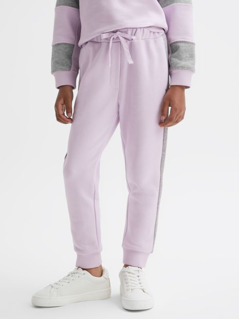 Pink joggers with white stripe on sale