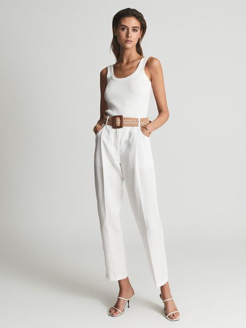 Tapered white linen trousers on sale