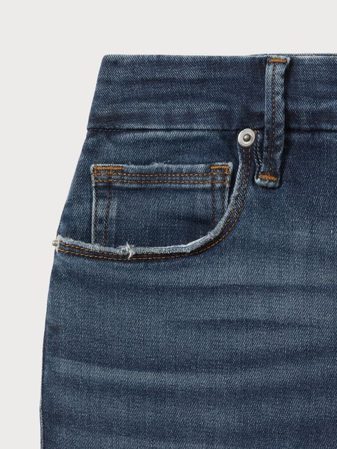 Good American Distressed Bootcut Jeans in Indigo