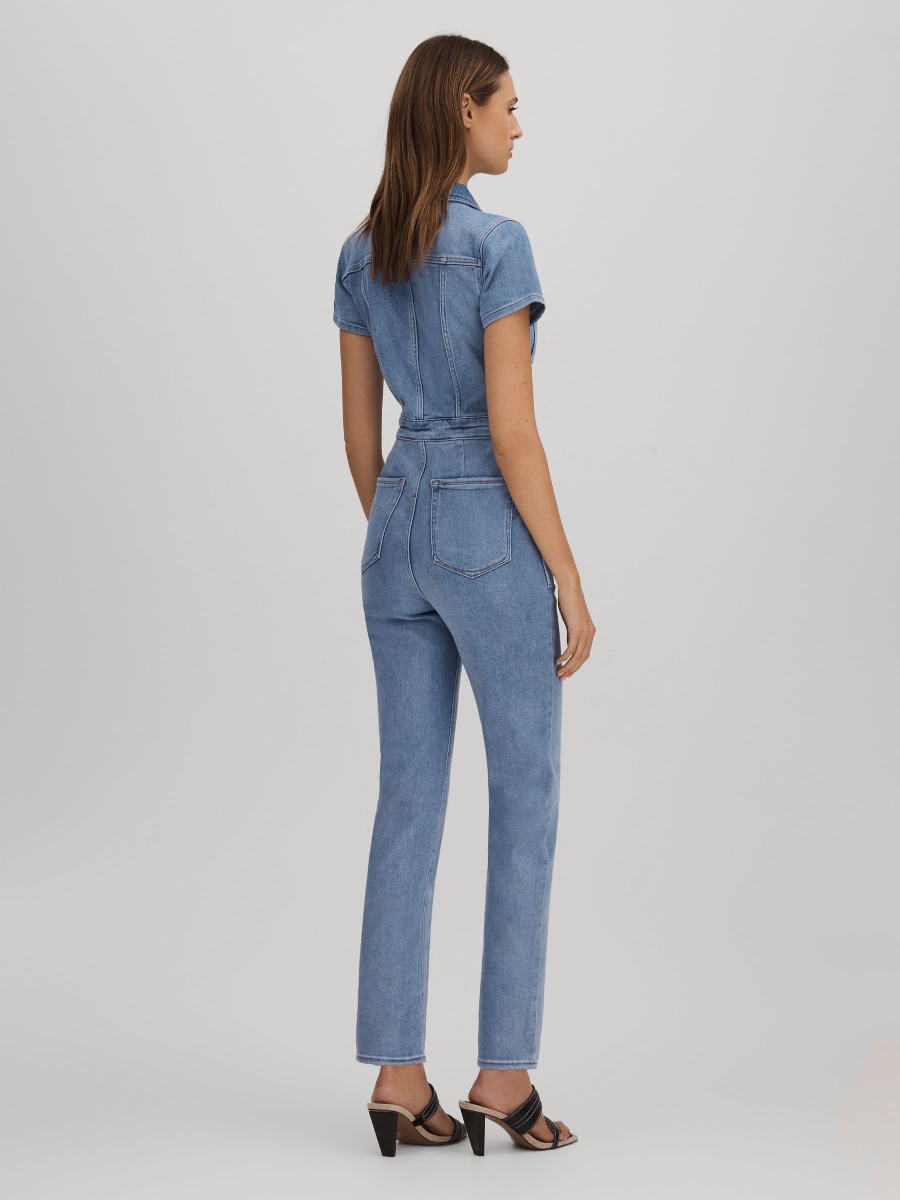Good American Denim Skinny Jumpsuit in Mid Blue - REISS