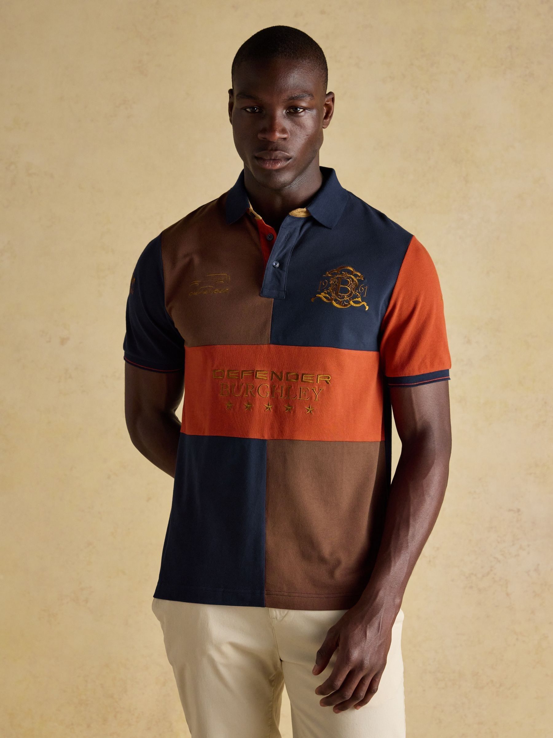 Official Burghley Orange/Navy Polo Shirt (AM4755) | £60