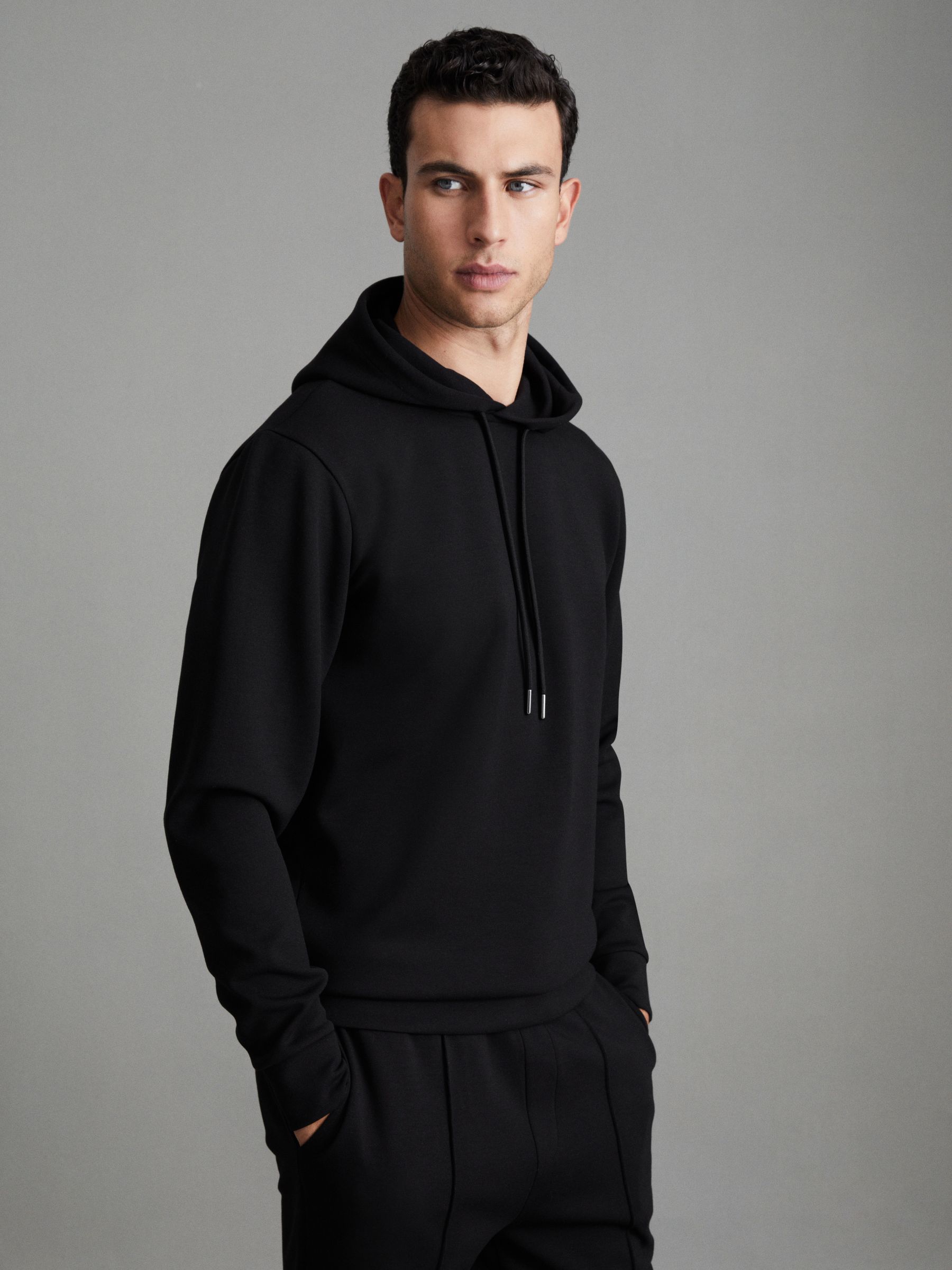 Interlock Jersey Drawstring Hoodie in Black - Image 1 of 7