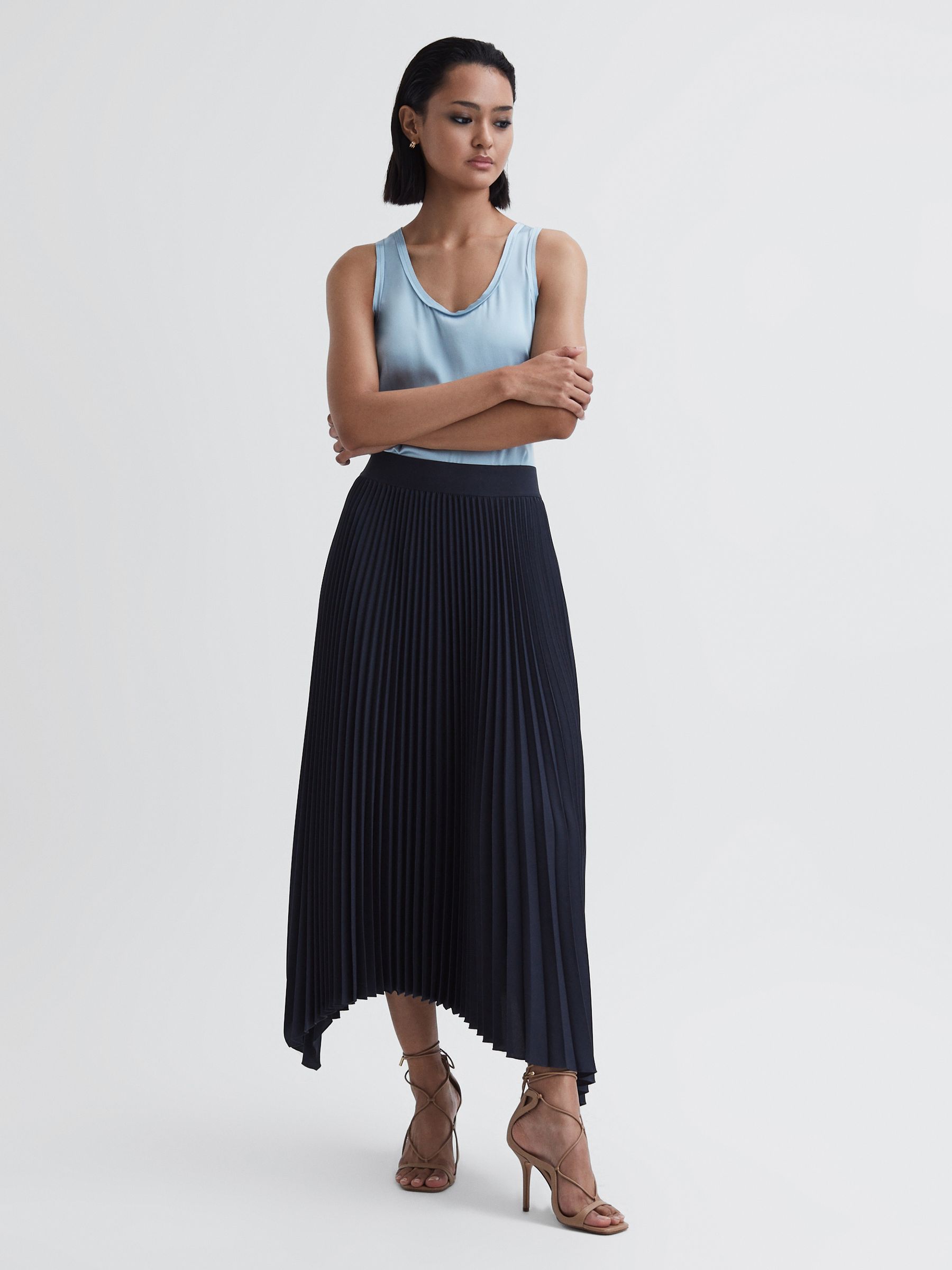 Pleated Asymmetric Midi Skirt in Navy - Image 1 of 4 Pleated Asymmetric Midi Skirt in Navy - Image 1 of 4