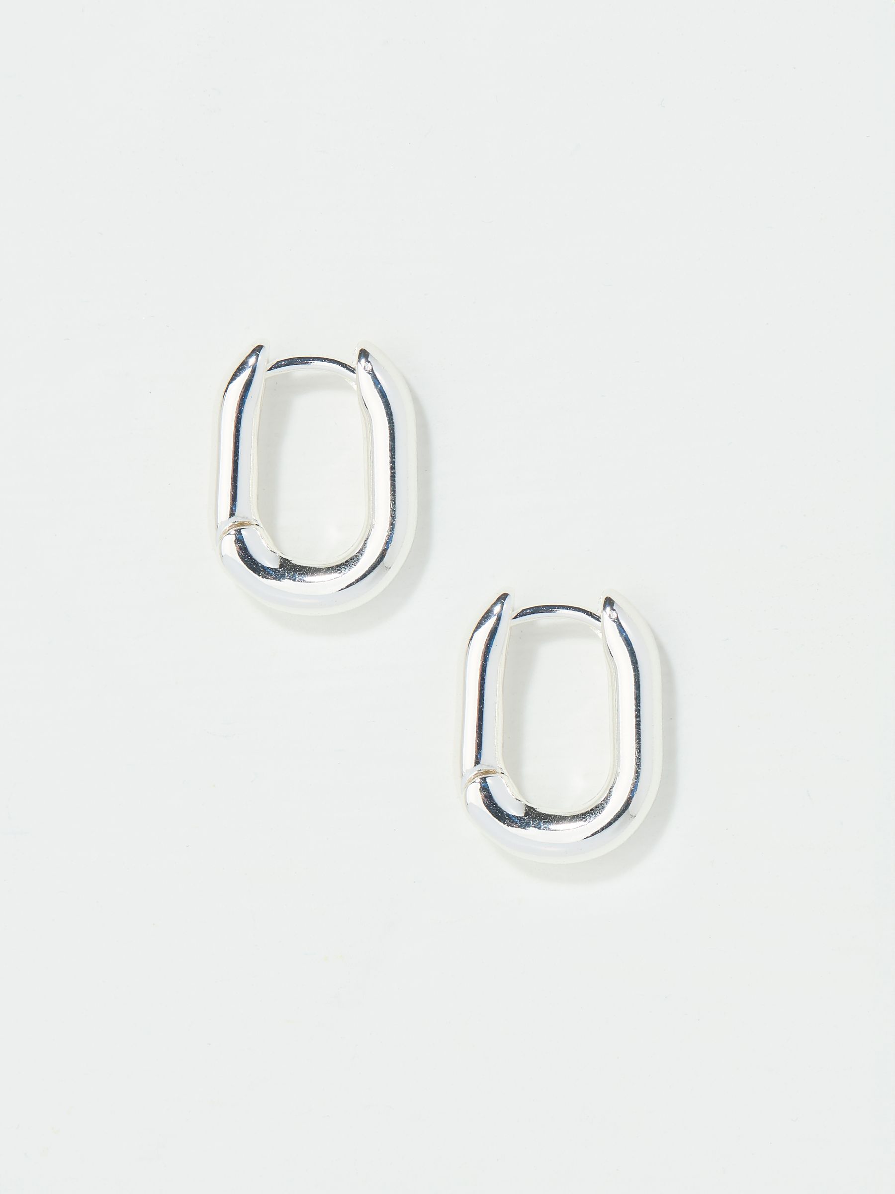 Silver Tone Oval Huggie Hoop Earrings - Image 1 of 3