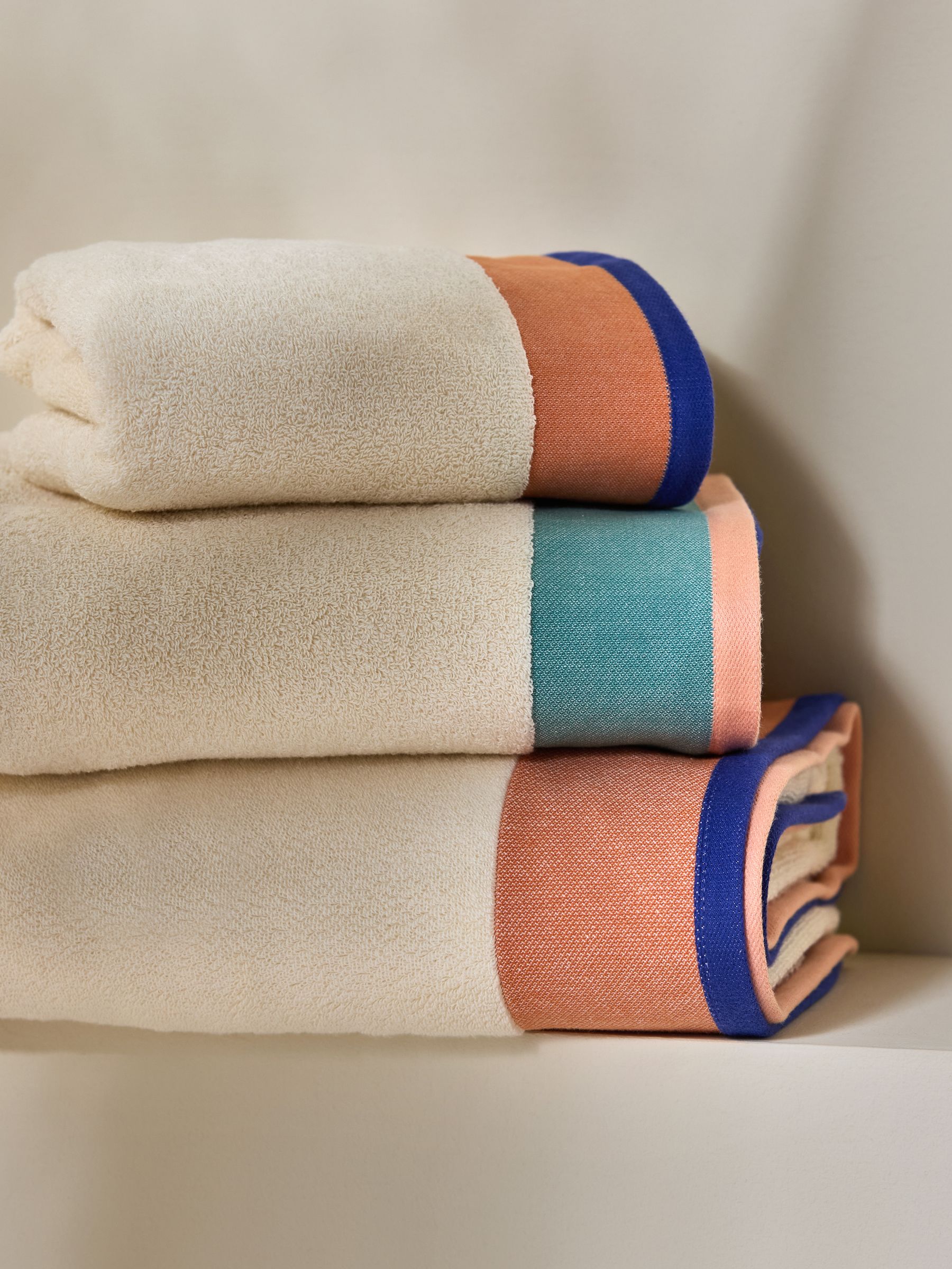 Dax Border 100% Cotton Towel in Peach and Blues - Image 1 of 3