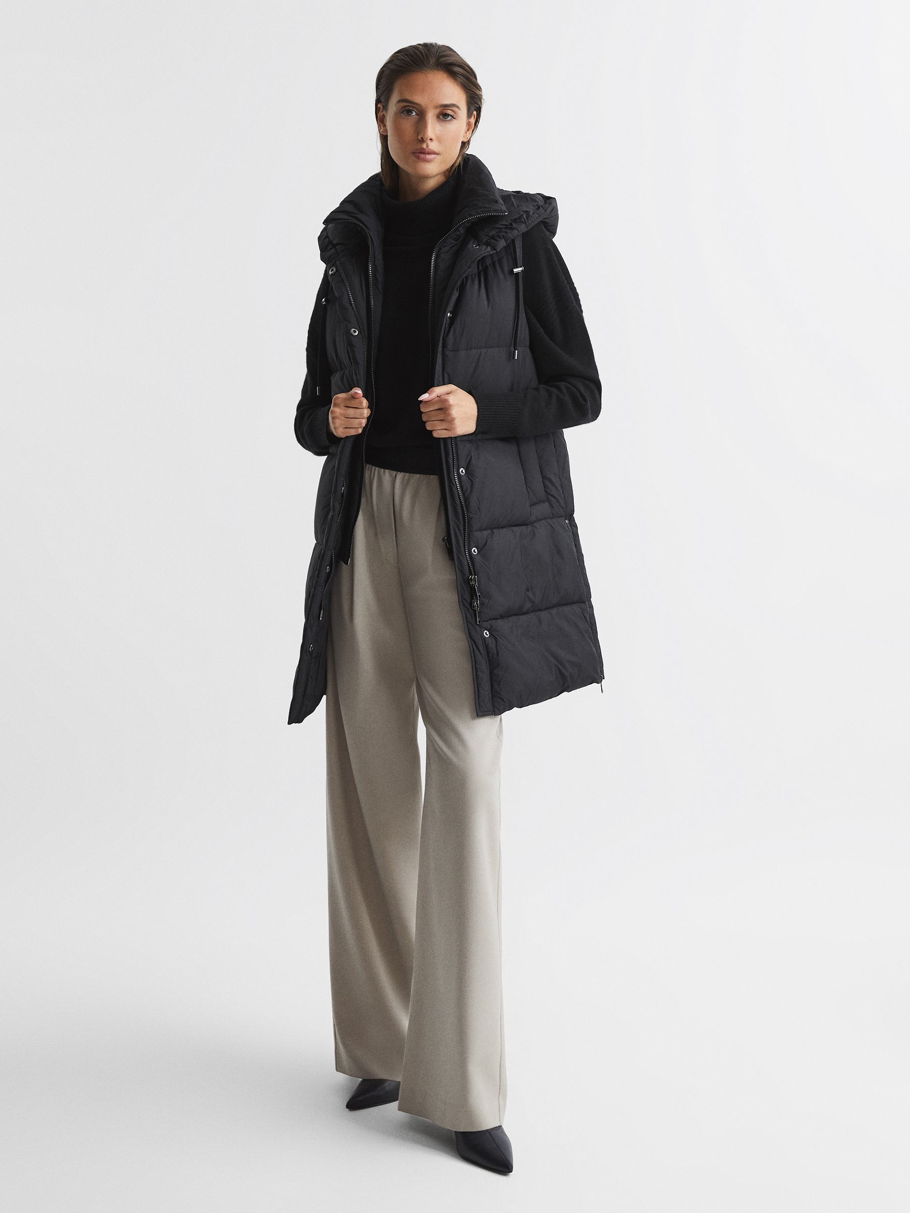 Hooded Long Sleeveless Puffer Gilet Coat in Black - Image 1 of 7 Hooded Long Sleeveless Puffer Gilet Coat in Black - Image 1 of 7