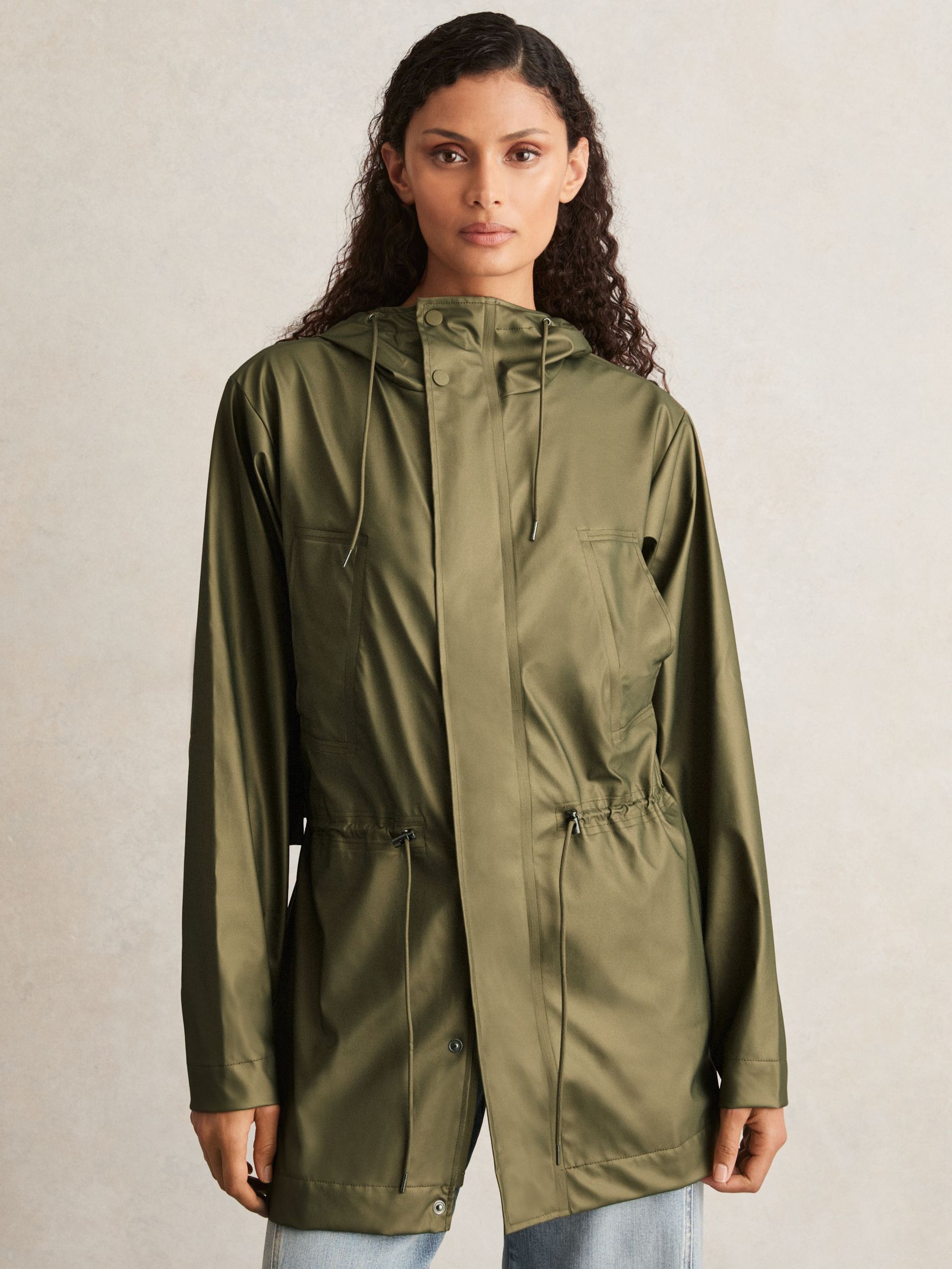 Rains Long Hooded Jacket in Revel Brass Green - Image 1 of 5 Rains Long Hooded Jacket in Revel Brass Green - Image 1 of 5