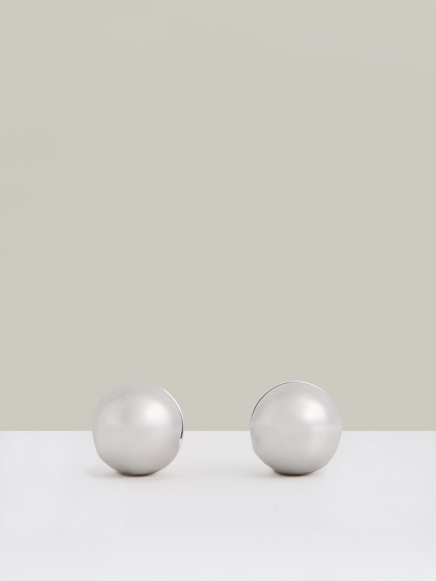 Polished Ball Huggie Earrings in Silver Tone - Image 1 of 4
