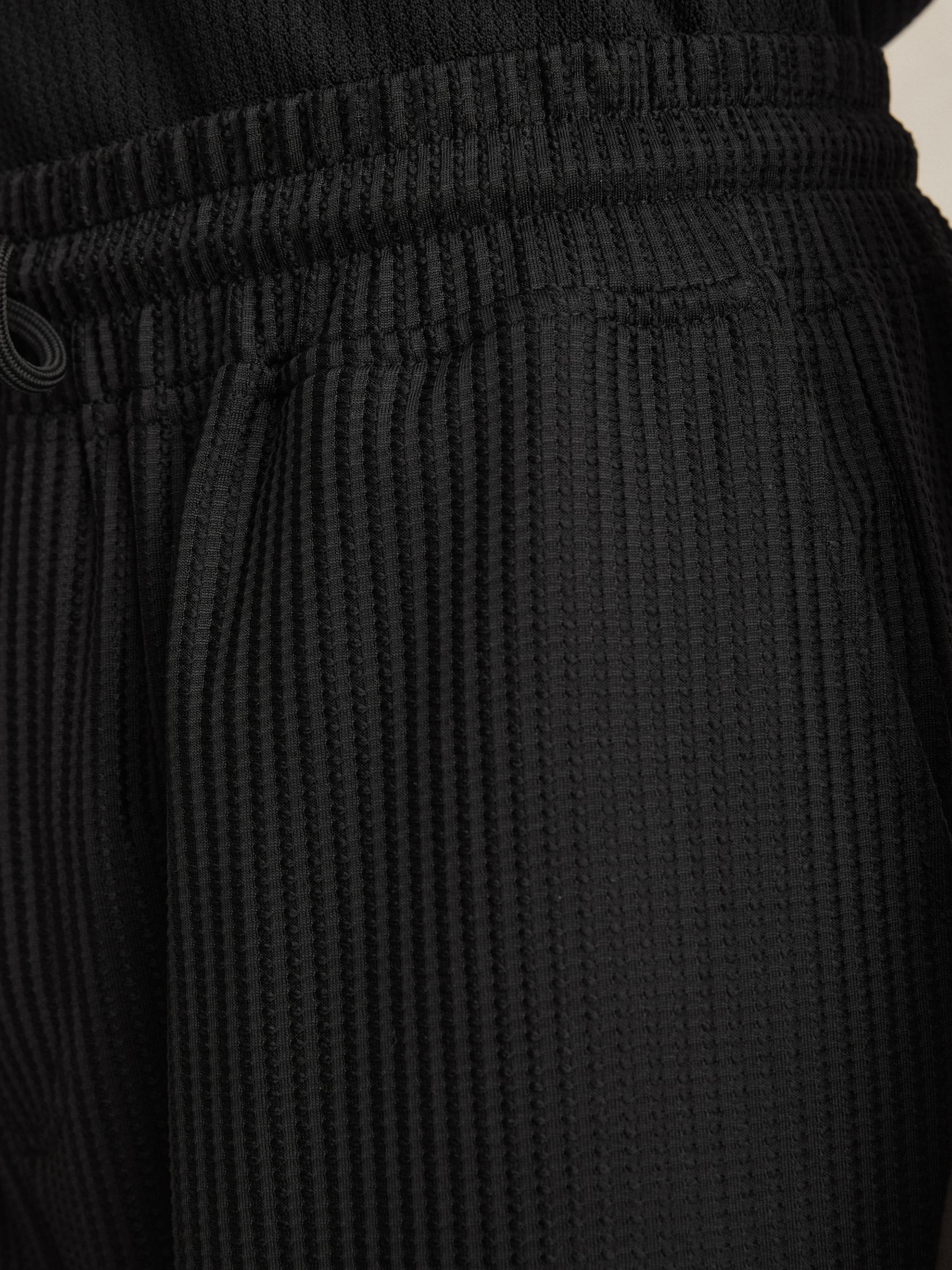 Textured-Knit Tapered Trousers in Black - image 4