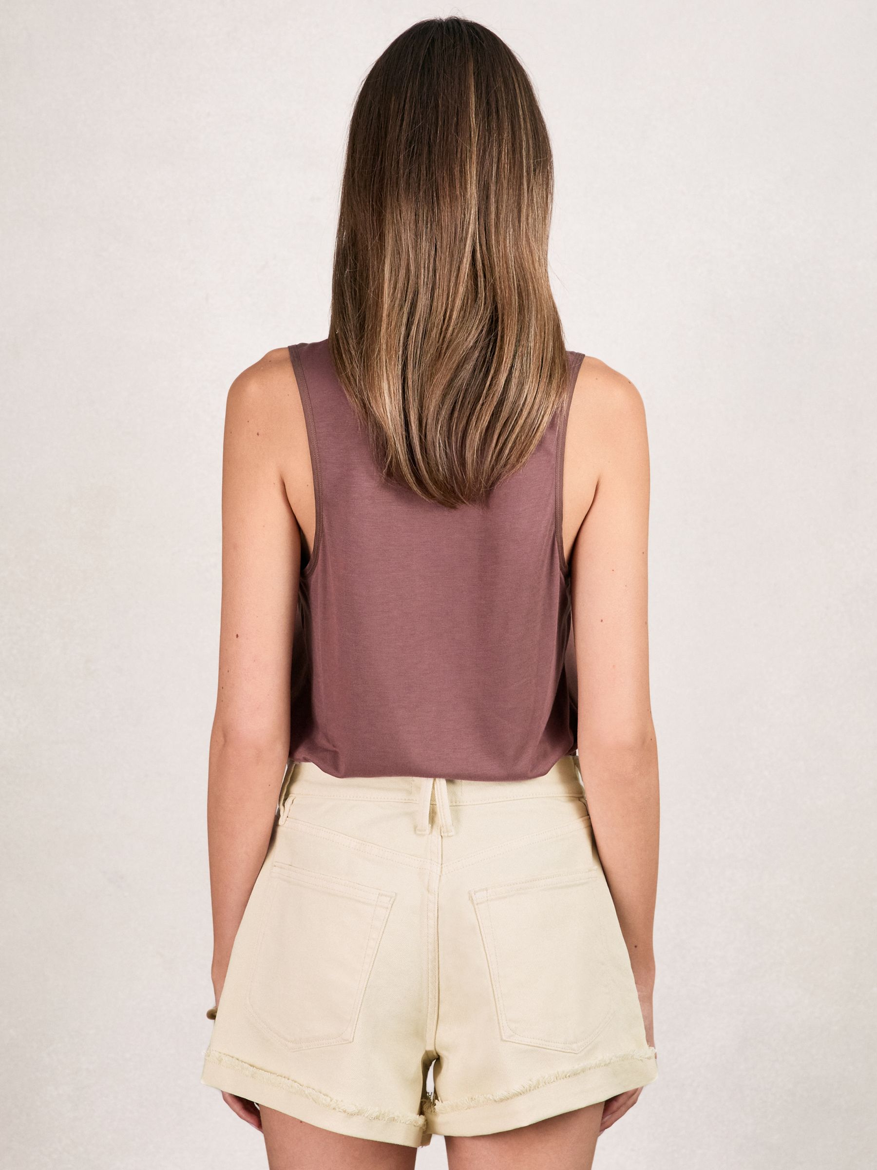 Good American Distressed Denim Shorts in Ecru - image 4