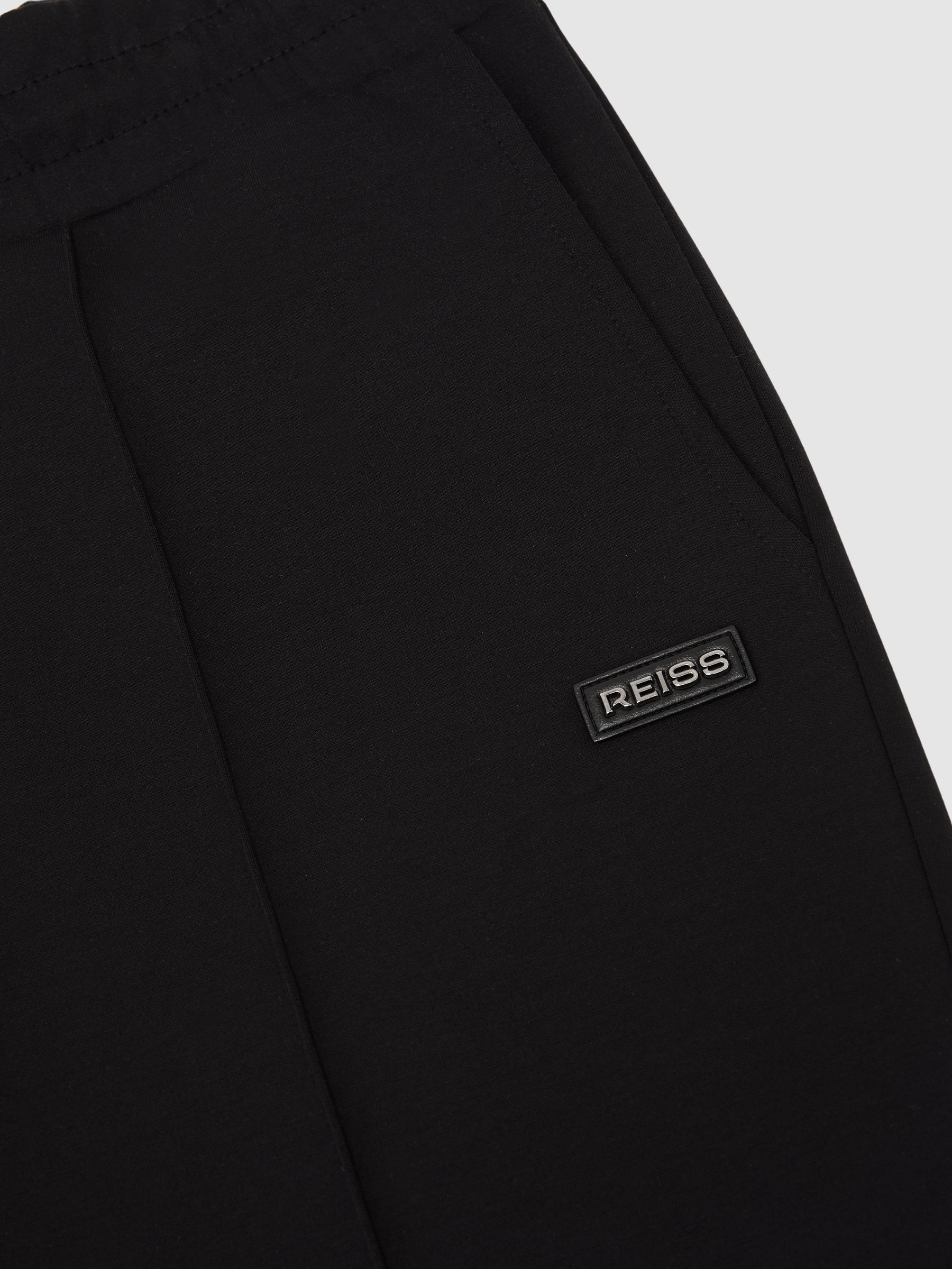 Premium Interlock Cuffed Logo Joggers in Black - image 4