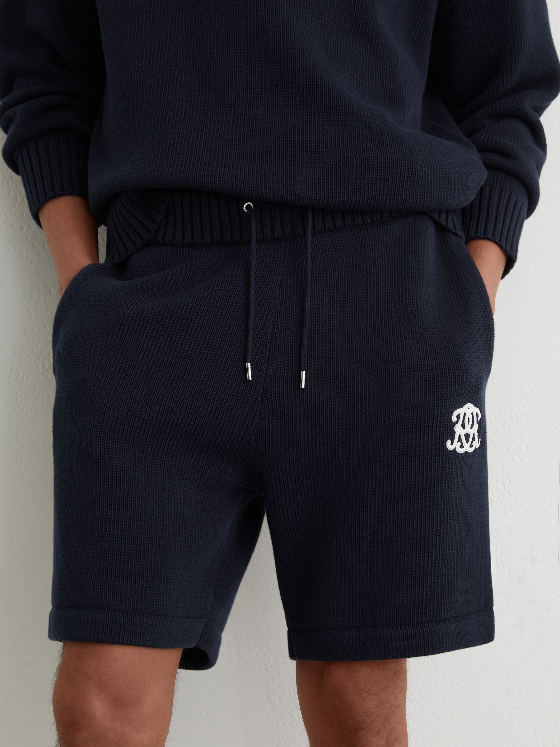 Monogram-Embroidered Relaxed Knit Shorts in Navy - Image 1 of 7 Monogram-Embroidered Relaxed Knit Shorts in Navy - Image 1 of 7