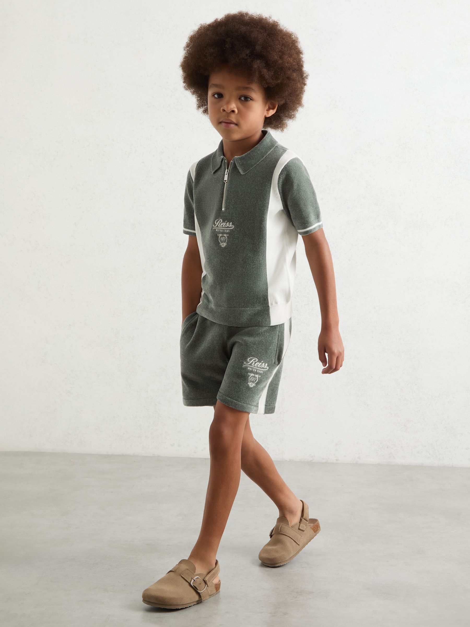 9-13 yrs Chenille Tipped Motor Cars Polo Shirt in Dark Sage Green/White - Image 1 of 4 9-13 yrs Chenille Tipped Motor Cars Polo Shirt in Dark Sage Green/White - Image 1 of 4