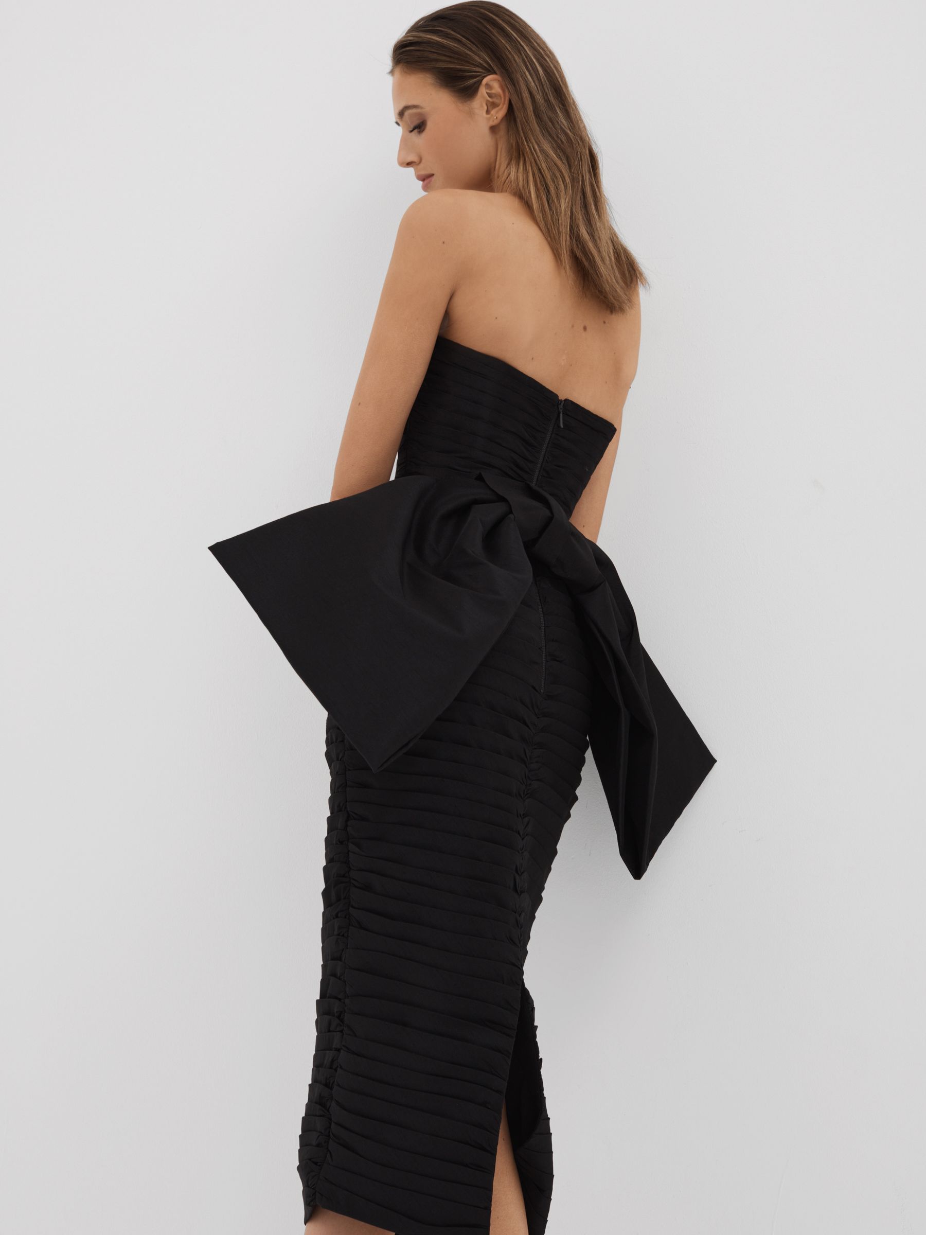 Rachel Gilbert Pleated Bow Back Midi Dress in Black - Image 1 of 4 Rachel Gilbert Pleated Bow Back Midi Dress in Black - Image 1 of 4