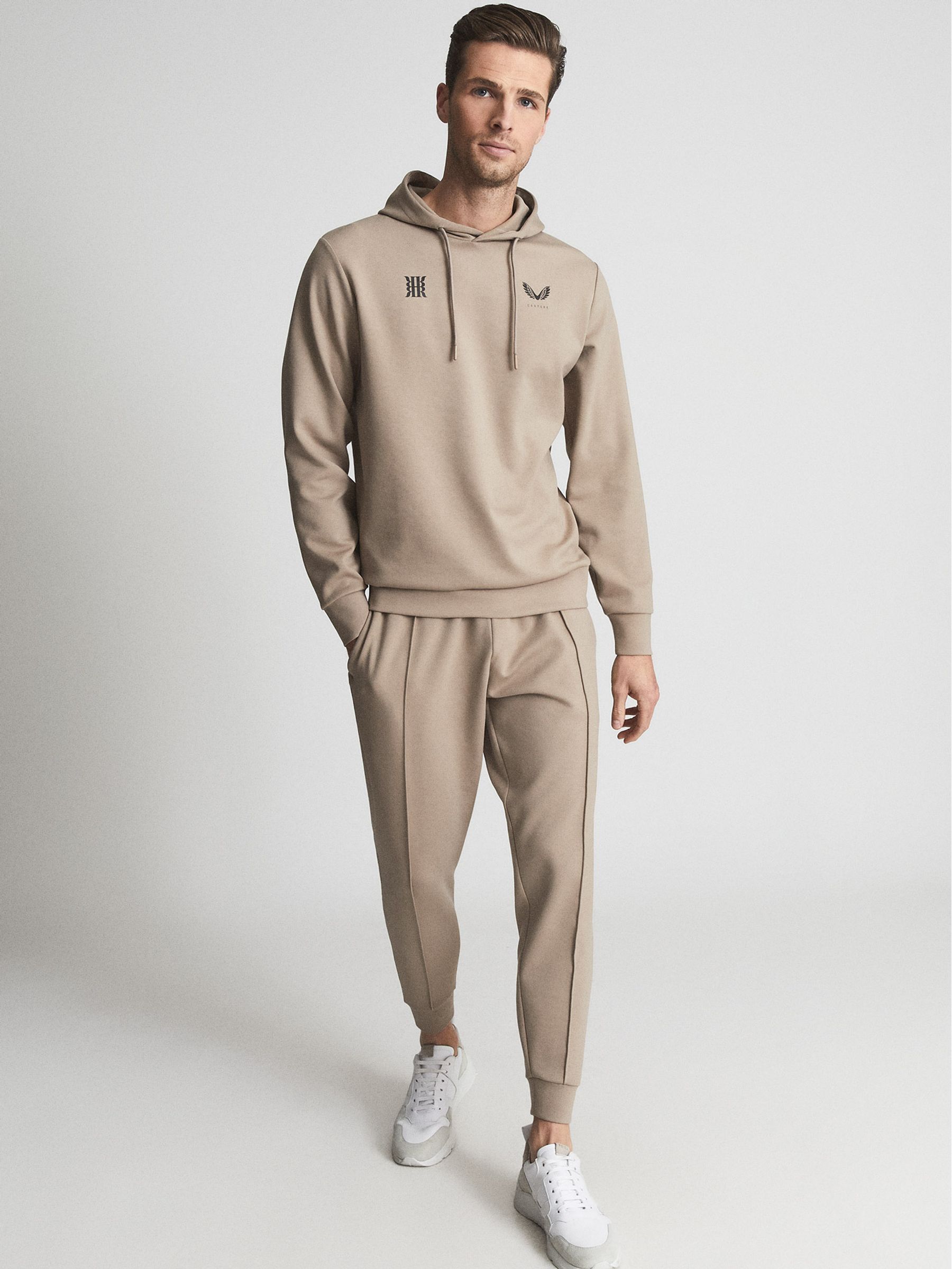 Reiss Castore Stretch Jersey Hoodie in Stone | REISS Reiss Castore Stretch Jersey Hoodie in Stone | REISS