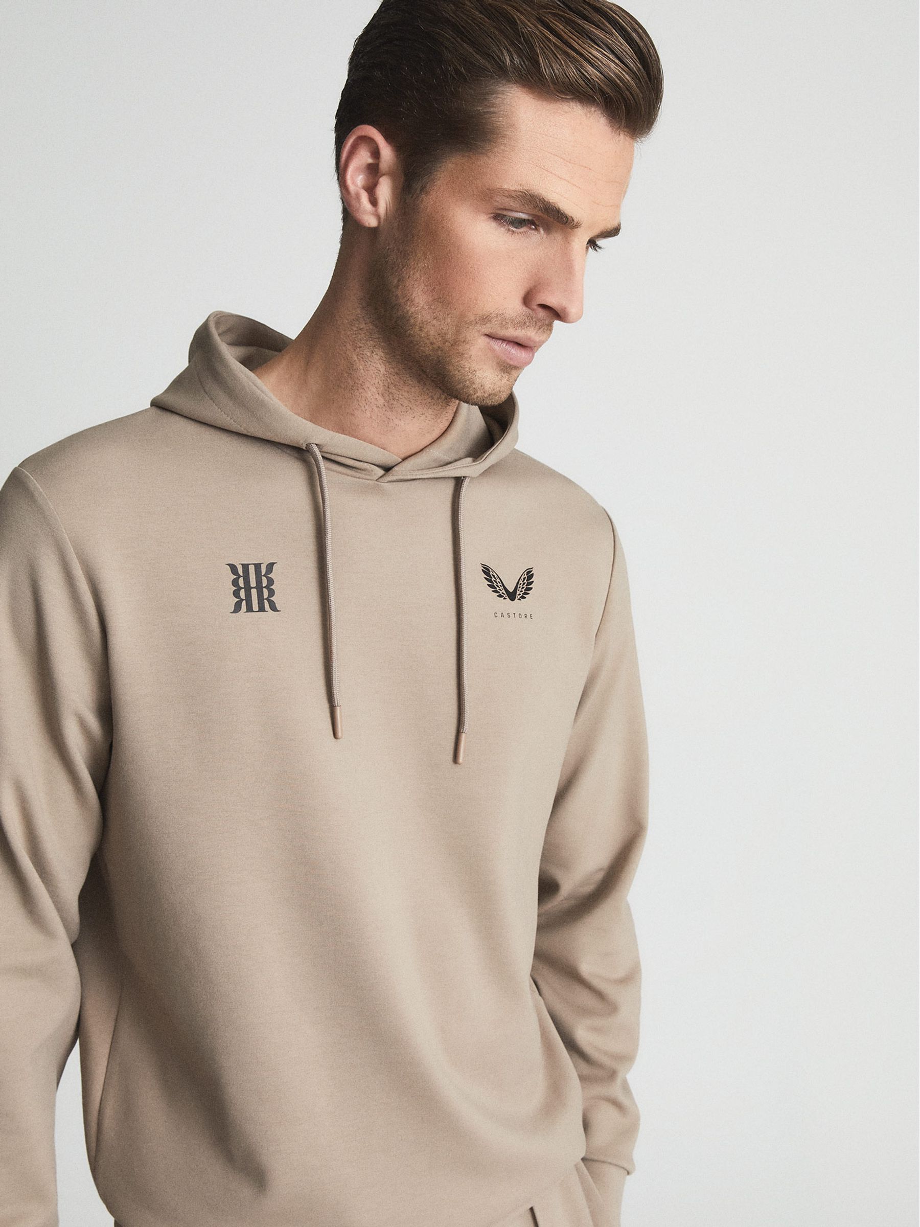 Reiss Castore Stretch Jersey Hoodie in Stone | REISS Reiss Castore Stretch Jersey Hoodie in Stone | REISS