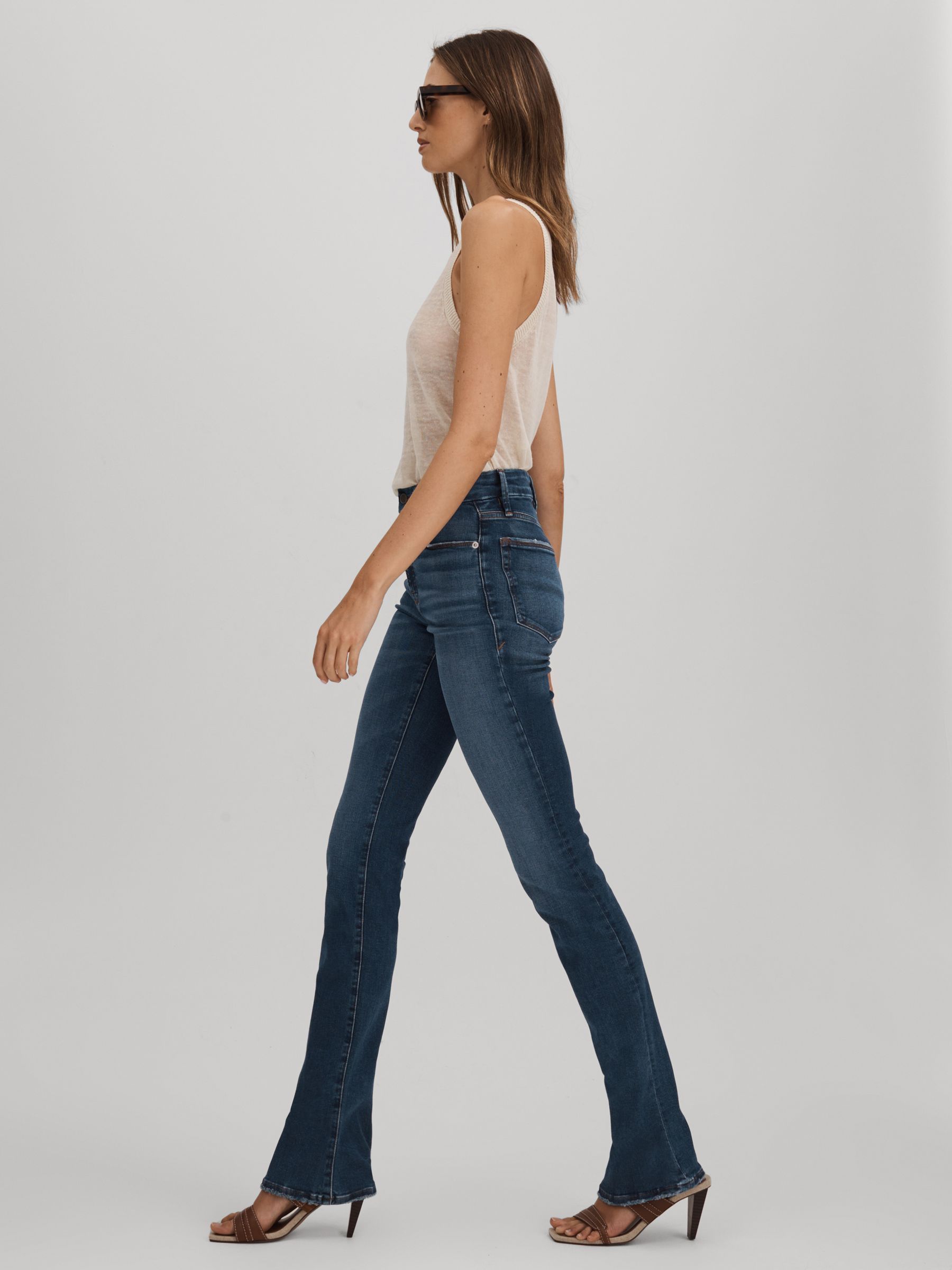 Good American Distressed Bootcut Jeans in Indigo - Image 1 of 5