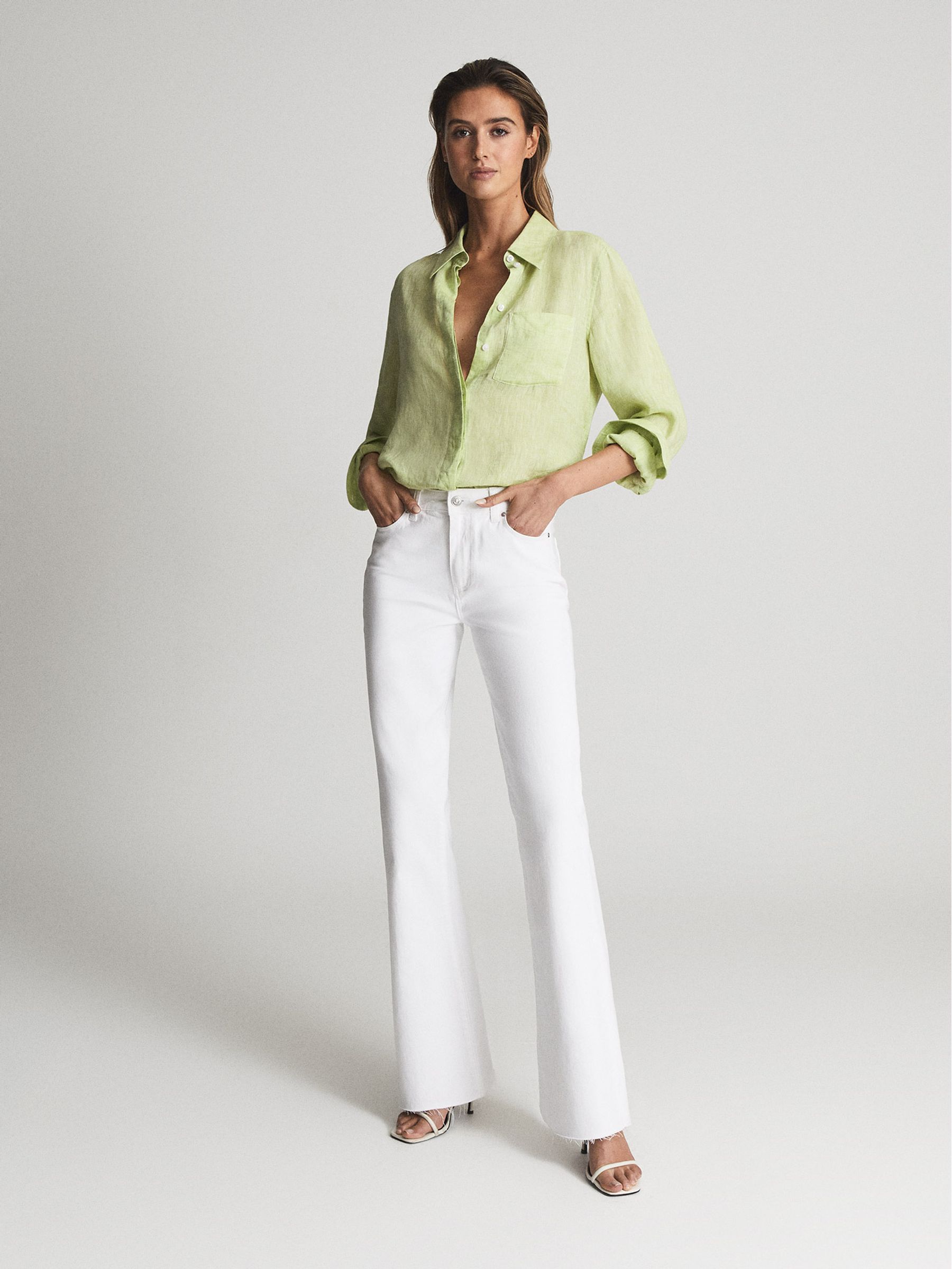 Paige High Rise Raw Hem Flared Jeans in White - Image 1 of 8