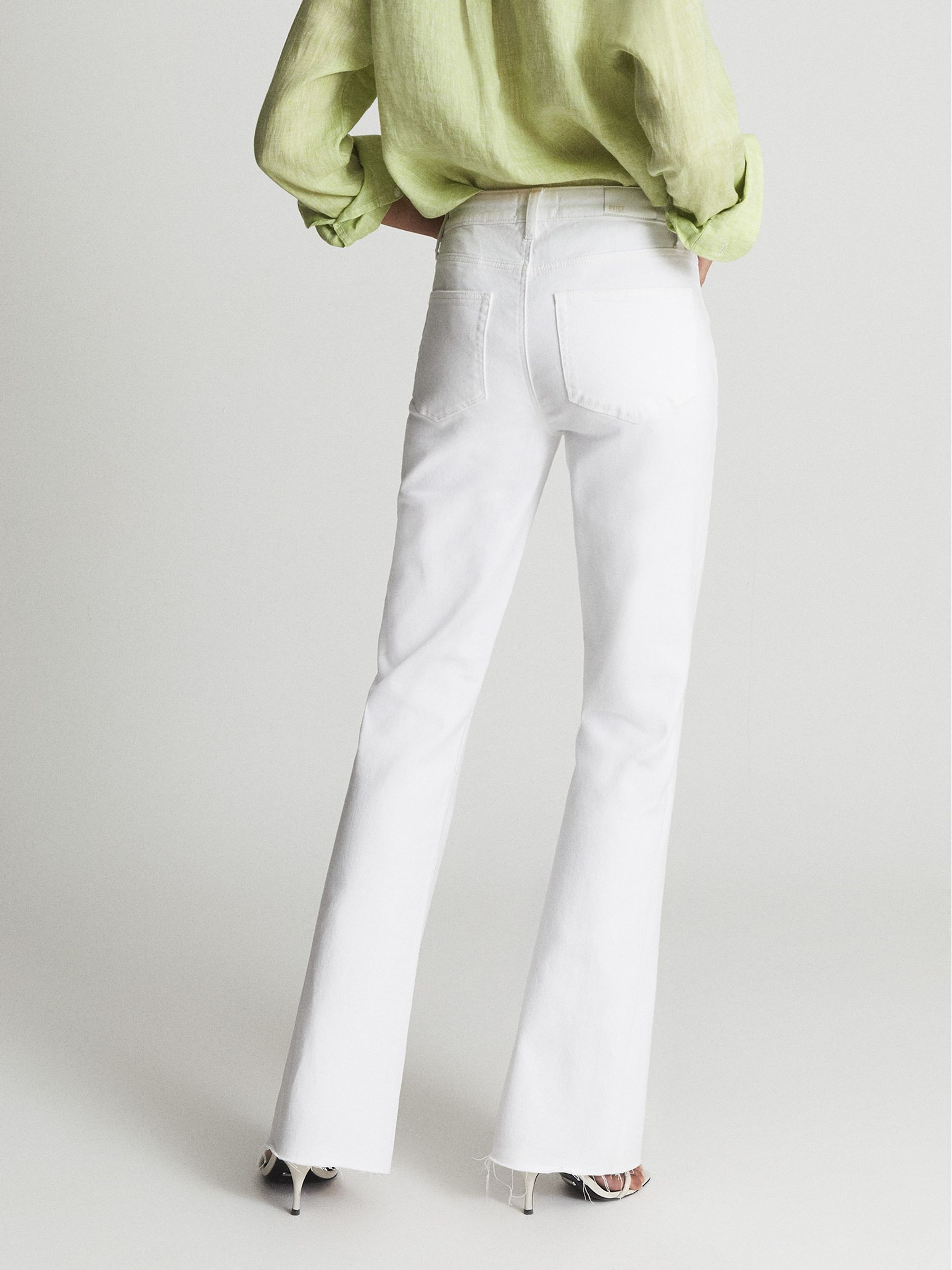 Paige High Rise Raw Hem Flared Jeans in White - Image 5 of 8