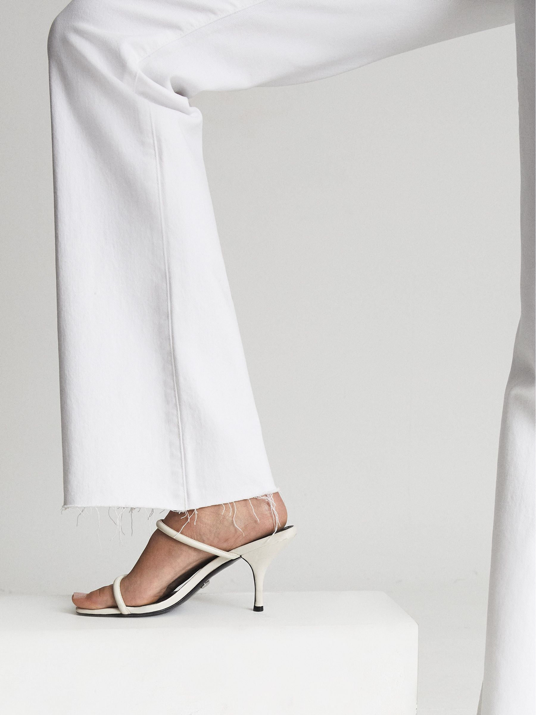 Paige High Rise Raw Hem Flared Jeans in White - Image 6 of 8