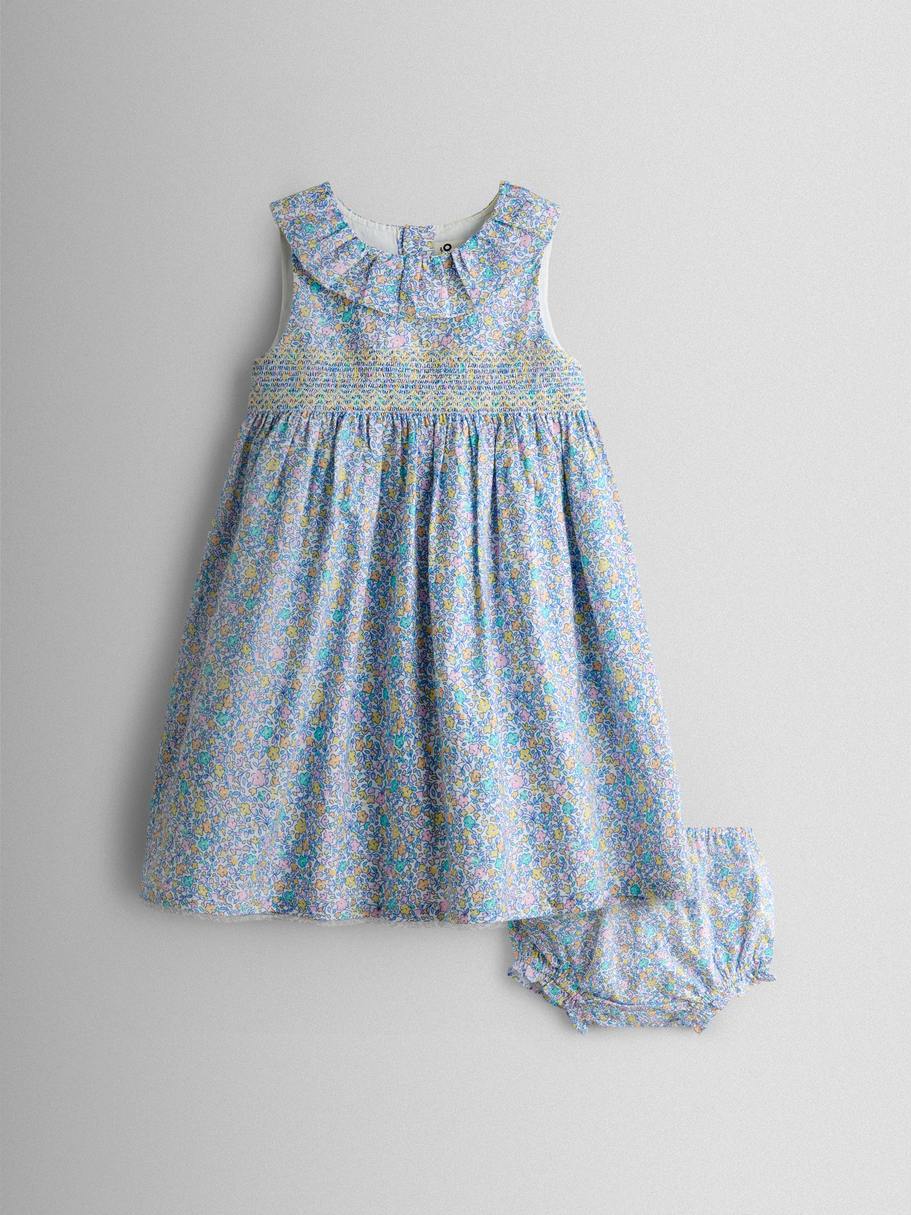 Blue Floral Sleeveless Smocked Floral Dress - Image 1 of 7 Blue Floral Sleeveless Smocked Floral Dress - Image 1 of 7