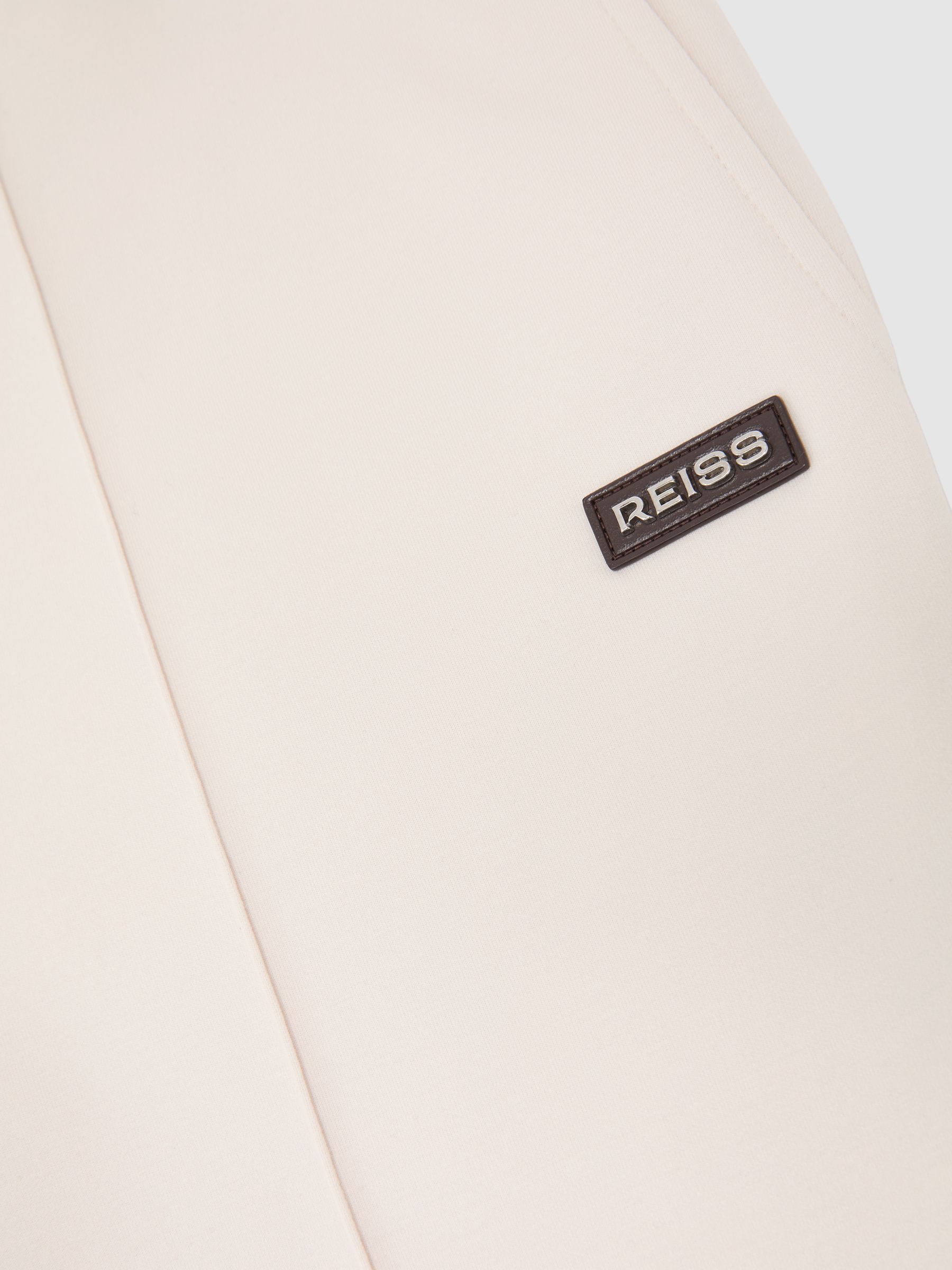 Premium Interlock Cuffed Logo Joggers in Off White - image 4