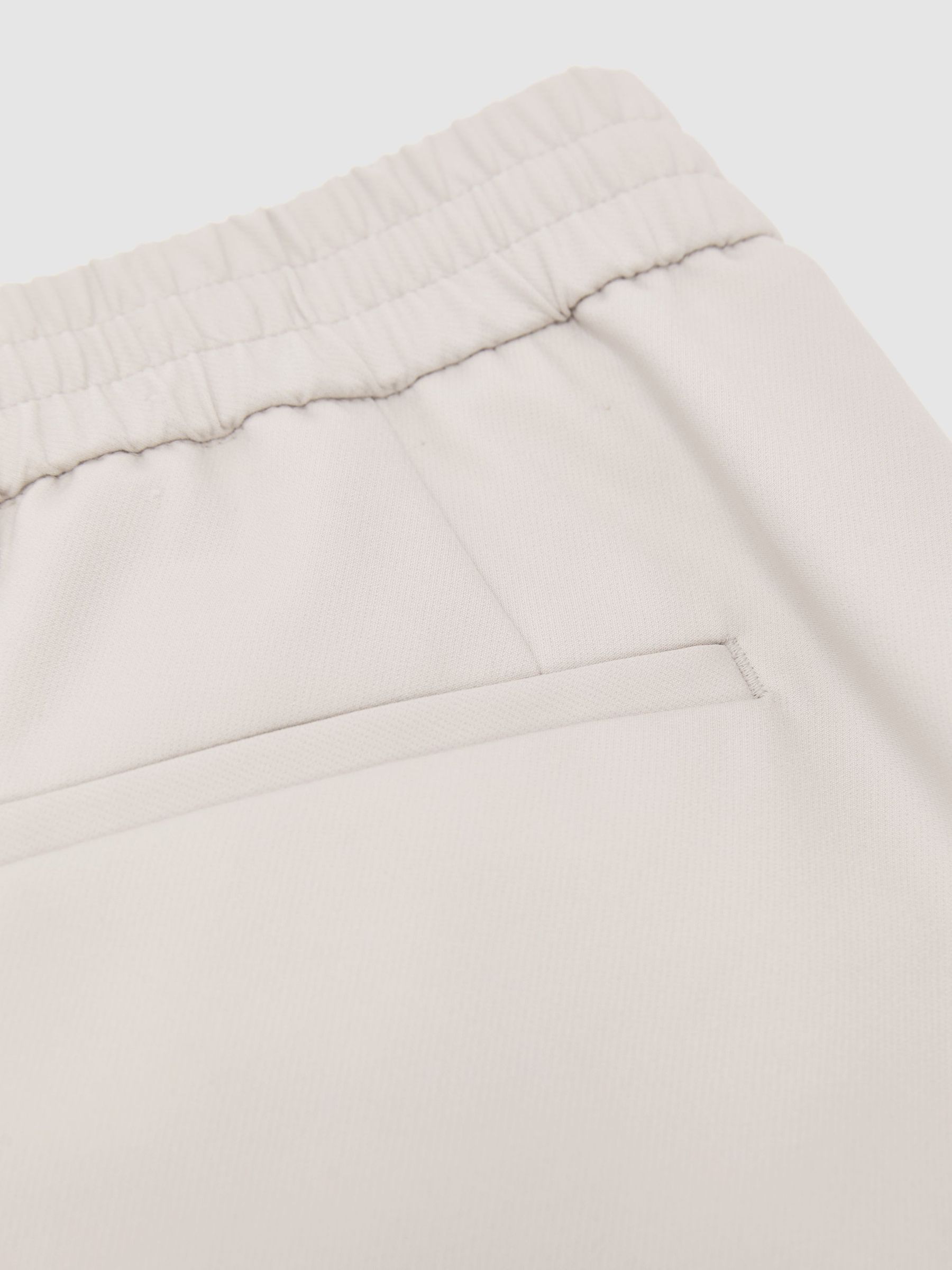 Technical Elasticated-Waist Tapered Trousers in Stone - image 3