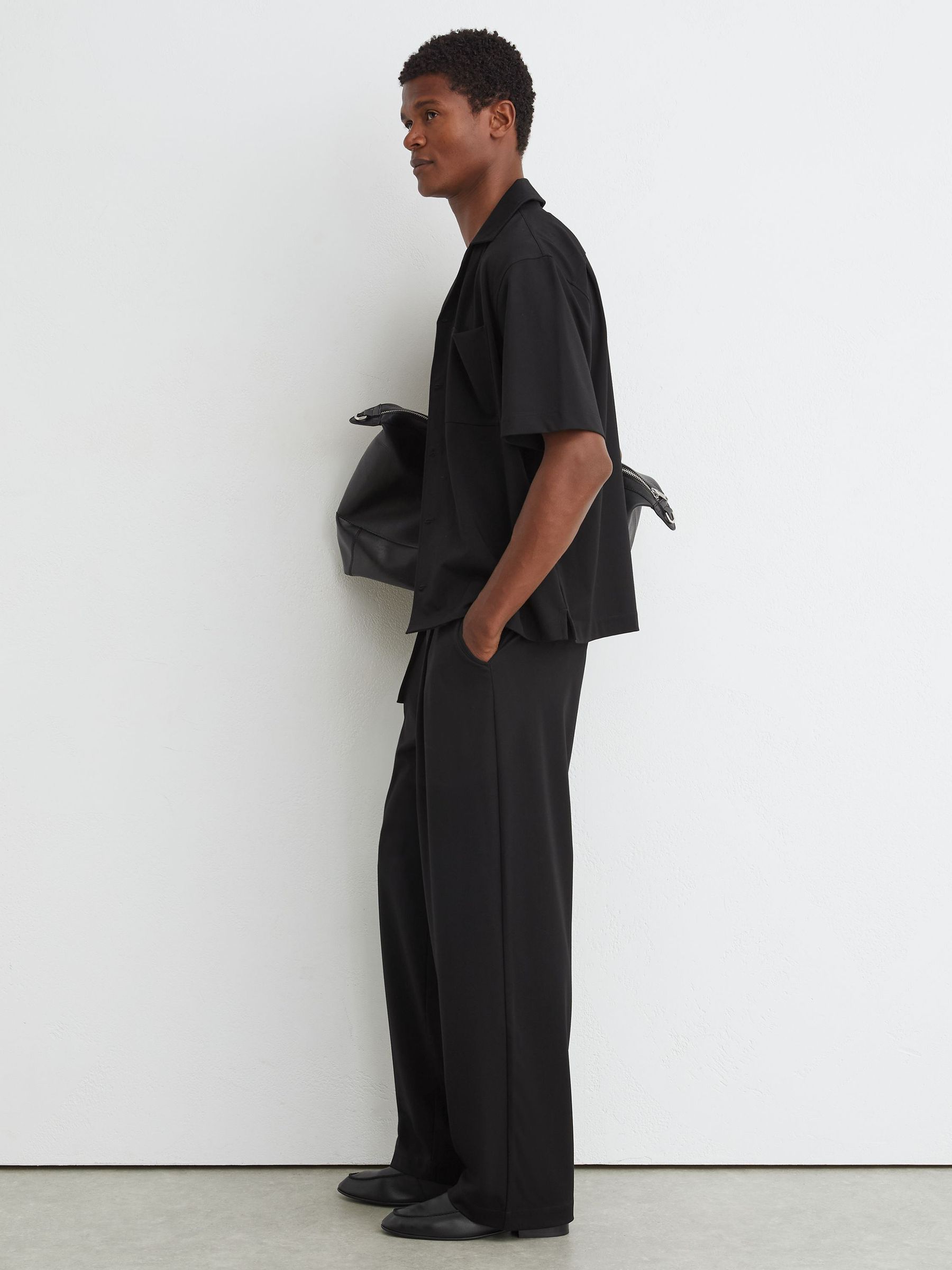 Belted Relaxed-Fit Pleated Trousers in Black - Image 1 of 7
